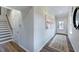 Bright entryway with hardwood floors, staircase, and coat closet at 274 Sweetbay Tree Dr, Wendell, NC 27591