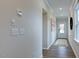 Hallway with light walls, wood floors, and neutral decor at 274 Sweetbay Tree Dr, Wendell, NC 27591