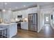 Modern kitchen with stainless steel appliances and island, open to a hallway at 274 Sweetbay Tree Dr, Wendell, NC 27591