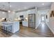 Modern kitchen with stainless steel appliances and island, open to a hallway at 274 Sweetbay Tree Dr, Wendell, NC 27591