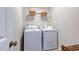Bright laundry room features washer, dryer, and shelving at 274 Sweetbay Tree Dr, Wendell, NC 27591