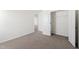 Bedroom with carpet, white walls, an open closet, and a door into the hall at 30 Rosewood Ln, Youngsville, NC 27596