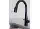 Close-up of matte black kitchen faucet over stainless steel sink at 30 Rosewood Ln, Youngsville, NC 27596