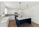 Beautiful kitchen featuring white cabinets, stainless steel appliances, a navy island, and modern pendant lights at 30 Rosewood Ln, Youngsville, NC 27596