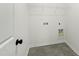 Cozy laundry room featuring tile flooring, wire shelf, and washer/dryer hookups at 30 Rosewood Ln, Youngsville, NC 27596