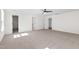Spacious main bedroom with carpet, ceiling fan and trim with three doorways to other areas of the home at 30 Rosewood Ln, Youngsville, NC 27596