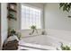 Bathroom with corner soaking tub and large window at 3018 E Cotton Gin Dr, Clayton, NC 27527