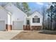 House exterior with a welcoming front porch and landscaping at 3018 E Cotton Gin Dr, Clayton, NC 27527