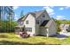 Spacious backyard with a patio, fire pit, grill, and screened porch at 3308 Eden Grove Rd, Fuquay Varina, NC 27526
