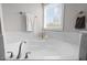 A bright bathroom features a soaking tub and an ample window at 3308 Eden Grove Rd, Fuquay Varina, NC 27526