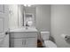 Bathroom featuring white vanity, sink, toilet, and tile flooring with a towel ring at 3308 Eden Grove Rd, Fuquay Varina, NC 27526