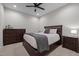 Cozy bedroom featuring a wooden bed frame, dresser, nightstands, ceiling fan, and carpet flooring at 3308 Eden Grove Rd, Fuquay Varina, NC 27526