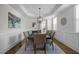 Elegant dining room with tray ceiling, stylish light fixture, and wainscoting at 3308 Eden Grove Rd, Fuquay Varina, NC 27526