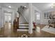 Bright entryway boasts hardwood floors and staircase leading upstairs at 3308 Eden Grove Rd, Fuquay Varina, NC 27526