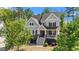 Charming two-story home boasts a beautiful front porch, gray siding, and well-manicured landscaping at 3308 Eden Grove Rd, Fuquay Varina, NC 27526