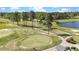 Elevated view of a beautiful golf course featuring a serene lake, green fairways and cart paths at 3308 Eden Grove Rd, Fuquay Varina, NC 27526
