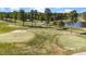 Aerial view of a beautiful golf course featuring lush green fairways, sand traps, and a serene pond at 3308 Eden Grove Rd, Fuquay Varina, NC 27526