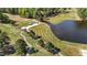 Scenic aerial view of a golf course with lush green fairways and a serene lake at 3308 Eden Grove Rd, Fuquay Varina, NC 27526