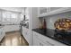 Modern kitchen featuring white cabinets, granite countertops, and stainless steel appliances at 3308 Eden Grove Rd, Fuquay Varina, NC 27526
