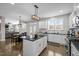 Bright kitchen boasts white cabinets, dark counters, island, and seamless flow into the adjacent dining and living area at 3308 Eden Grove Rd, Fuquay Varina, NC 27526