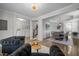 Open-concept living area flows into dining area with modern lighting fixtures and stylish furnishings at 3308 Eden Grove Rd, Fuquay Varina, NC 27526