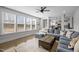Bright living room with large windows, a comfortable sectional, and an open floor plan at 3308 Eden Grove Rd, Fuquay Varina, NC 27526