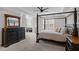 A relaxing main bedroom features a four-poster bed, tray ceilings, and neutral walls at 3308 Eden Grove Rd, Fuquay Varina, NC 27526