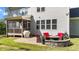 Comfortable patio with stone fire pit, wicker chairs, and outdoor grill; screened porch nearby at 3308 Eden Grove Rd, Fuquay Varina, NC 27526