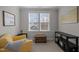 This well-lit sitting area has a large window, chair, and neutral colored carpet at 3308 Eden Grove Rd, Fuquay Varina, NC 27526