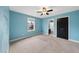 Bedroom with ceiling fan and view into bathroom at 3425 Grosbeak Way, Raleigh, NC 27616