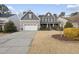 Two story home with gray siding, white trim, and a stone facade at 3425 Grosbeak Way, Raleigh, NC 27616