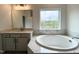 Bathroom featuring soaking tub, vanity and view from the window at 4408 Emeline Way # 34, Fuquay Varina, NC 27526