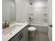 Modern bathroom featuring a vanity, toilet, and shower-tub combination with sleek fixtures at 4408 Emeline Way # 34, Fuquay Varina, NC 27526