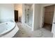 Elegant bathroom showcasing a soaking tub, glass shower, and dual vanity at 4408 Emeline Way # 34, Fuquay Varina, NC 27526