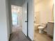 Well-lit bathroom with tiled floor, toilet and shower/bath and storage cabinet at 4408 Emeline Way # 34, Fuquay Varina, NC 27526