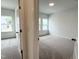 Bright bedroom with neutral carpet and large windows for ample natural light at 4408 Emeline Way # 34, Fuquay Varina, NC 27526
