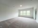 Spacious bedroom featuring plush carpeting and natural light from multiple windows at 4408 Emeline Way # 34, Fuquay Varina, NC 27526