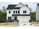Beautiful two-story home with white siding, black roof, and stone accents at 4408 Emeline Way # 34, Fuquay Varina, NC 27526