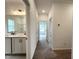 Hallway leading to bathroom and bedrooms, showcasing layout and carpet flooring at 4408 Emeline Way # 34, Fuquay Varina, NC 27526