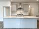 Bright, modern kitchen featuring a large island, pendant lights, and stainless steel appliances at 4408 Emeline Way # 34, Fuquay Varina, NC 27526