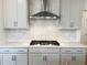 Kitchen showcases sleek cabinets, a stylish backsplash, and a stainless steel range hood at 4408 Emeline Way # 34, Fuquay Varina, NC 27526