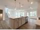 Open floor plan featuring a kitchen island with pendant lighting and stainless steel appliances at 4408 Emeline Way # 34, Fuquay Varina, NC 27526