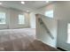 Bright loft space with neutral carpeting, natural light, and staircase at 4408 Emeline Way # 34, Fuquay Varina, NC 27526