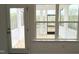 View through a window to a screened porch with a white railing and wood floor at 4408 Emeline Way # 34, Fuquay Varina, NC 27526