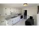 Well-lit kitchen features white cabinets, black hardware, and essential appliances at 512 E Branch St, Spring Hope, NC 27882