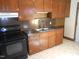 Kitchen with dark wood cabinets and granite countertops at 512 E Branch St, Spring Hope, NC 27882