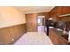 Functional kitchen area with wooden cabinets, essential appliances and a view into the living area at 512 E Branch St, Spring Hope, NC 27882