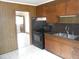 Kitchen with dark wood cabinets and granite countertops at 512 E Branch St, Spring Hope, NC 27882