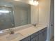 Bathroom featuring double sinks, white quartz countertops, and gray cabinets at 54 Cultivator Ct, Angier, NC 27501