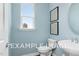Powder room with light blue walls and updated fixtures at 54 Cultivator Ct, Angier, NC 27501
